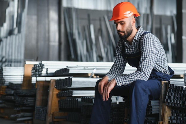 Factory worker measures the metal profile