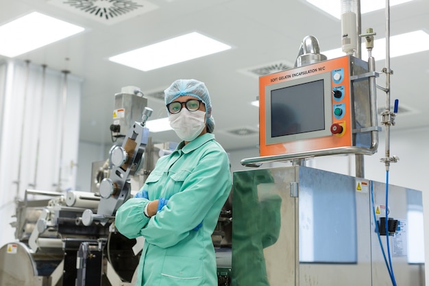 Photo factory worker stand near control panel