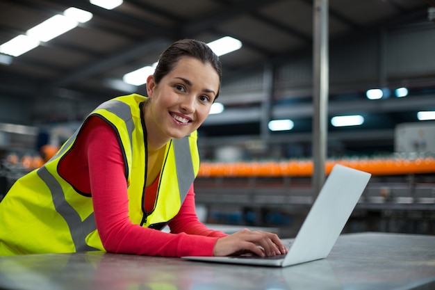 Factory worker using laptop