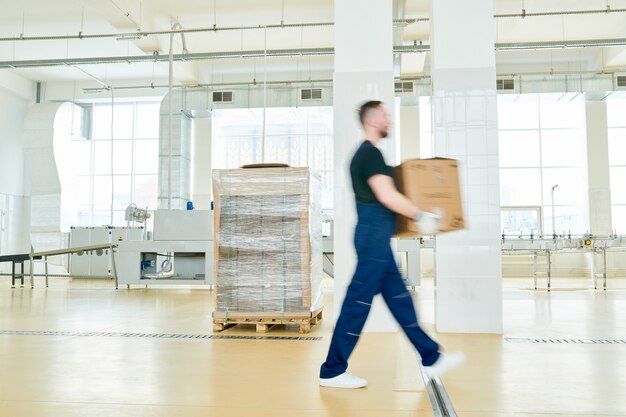 Factory Worker with Cardboard Box