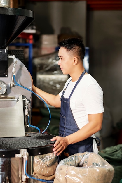 Factory worker working on coffee machine