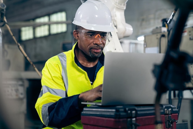 Factory worker working with laptop computer to do adept\
procedure checklist