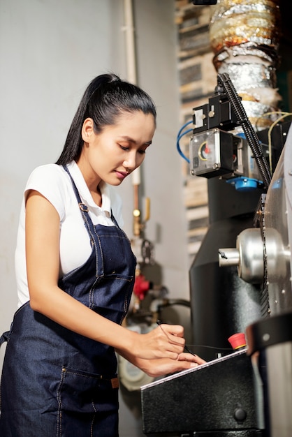 Factory worker working with machine