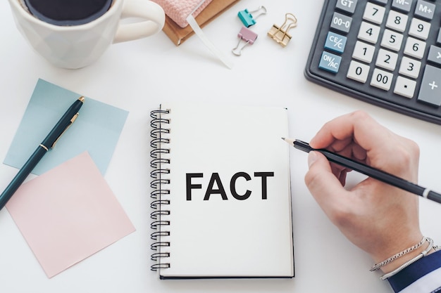 FACTS text on notebook on office table