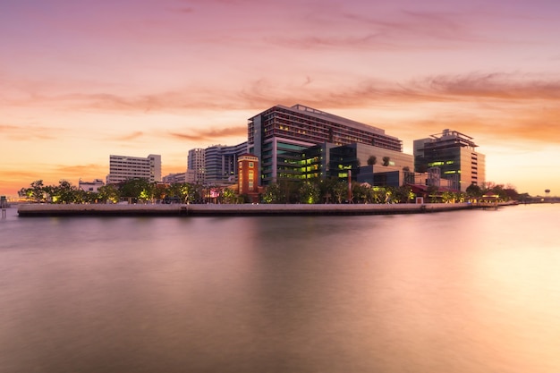 Faculty of Medicine Siriraj Hospital (public hospital) at twilight time in the Chao Phraya River, Bangkok, Thailand