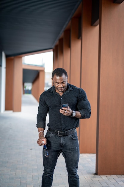 Fahionable elegant male model in darl casual cloth portrait of young man in black shirt