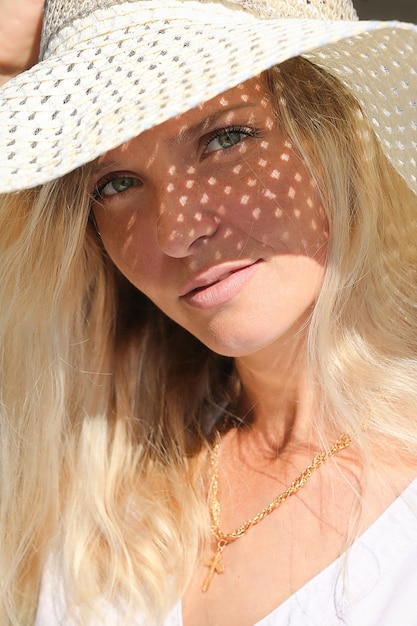 Fair-haired girl in a hat, full face