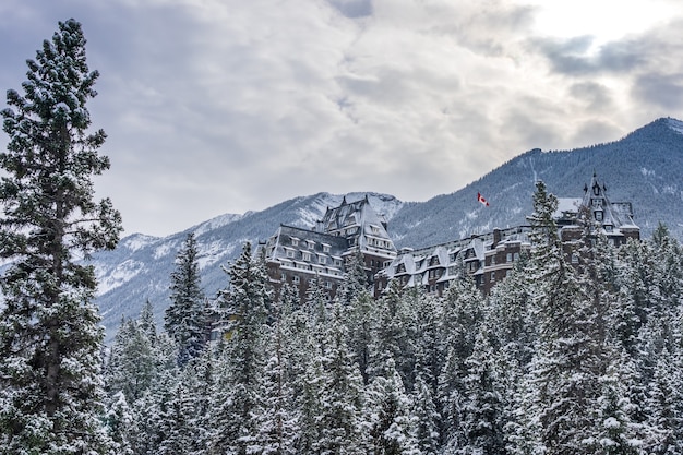 Фото fairmont banff springs в зимний солнечный день. национальный парк банф, канадские скалистые горы.