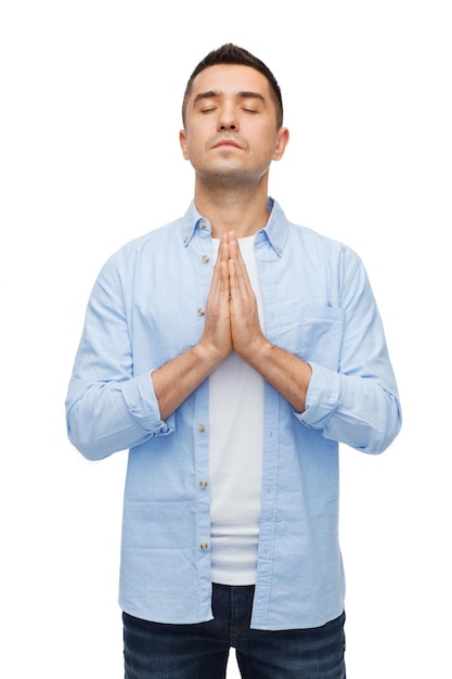 faith in god, religion and people concept - happy man with closed eyes praying