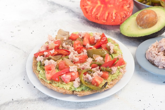 Fajitas with tortilla mix tomato pepper tuna onion and avocado on white background