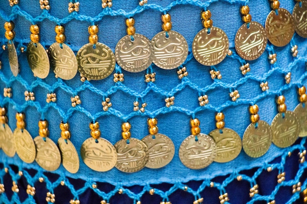 Fake gold coins are on the scarf edges