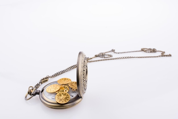 Photo fake gold coins on a pocket watch