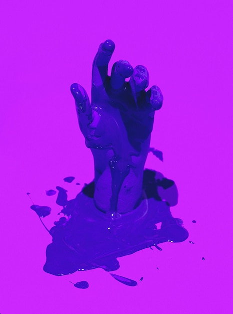 Fake hand and blue paint on purple background minimalist creative stylish wallpaper