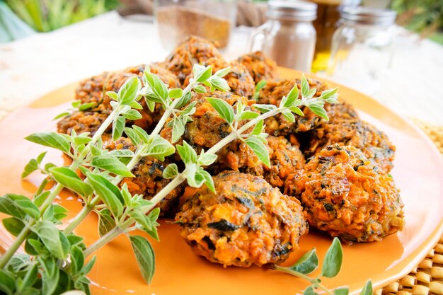 Falafel prepared with carrots and various spices