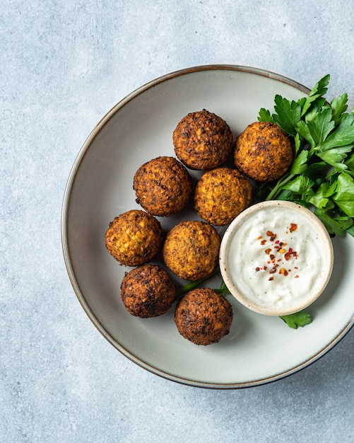 Falafel with sauce on a blue background view from above selective focus