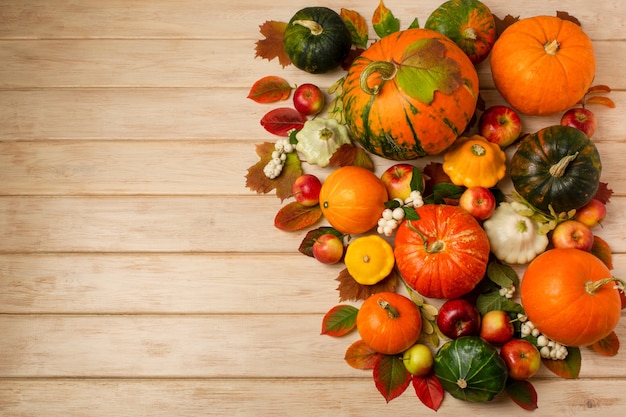 Photo fall arrangement with green orange striped pumpkins snowberry leaves yellow and white squash