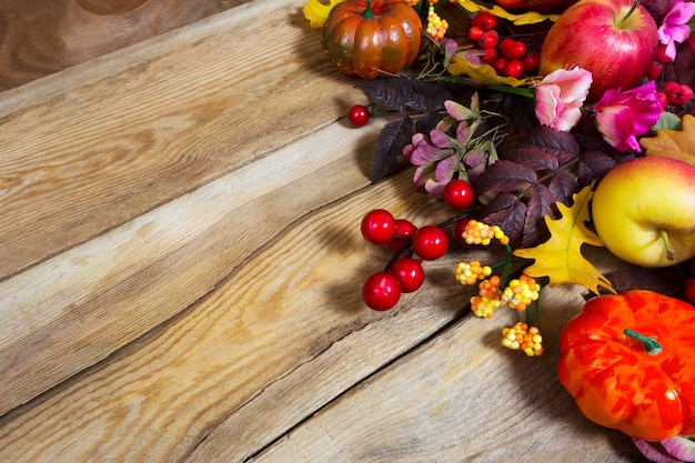 Fall arrangement with pumpkins and pink flowers, 