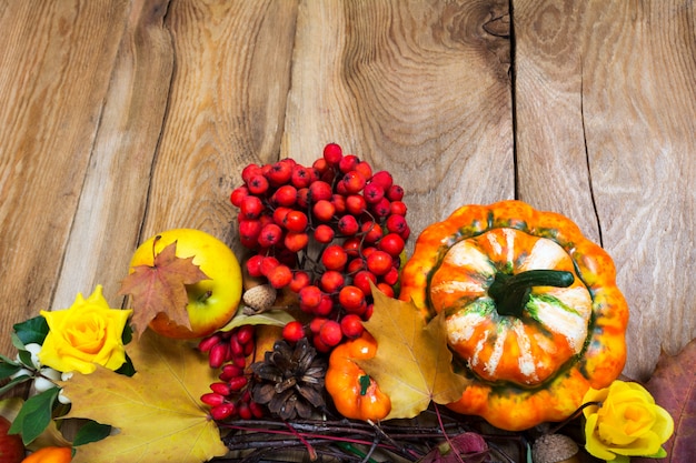 Fall background on the rustic wooden table, copy space