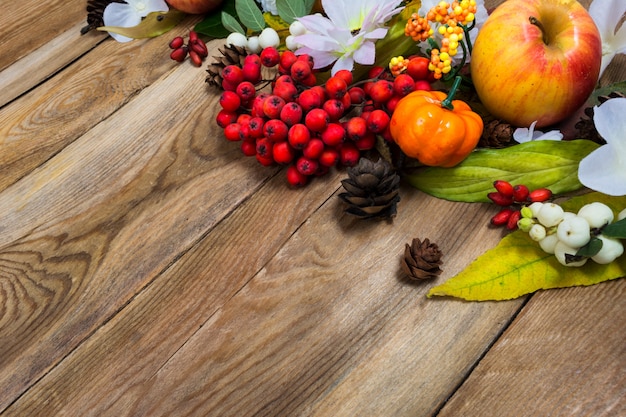 Photo fall decor with small pumpkin on wooden table, copy space