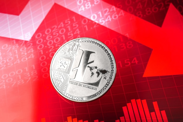 Fall of litecoin cost and value price, cryptocurrency crisis\
concept, red down arrow and stock chart graphs on the background\
photo