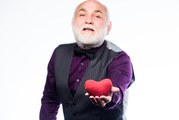 Fall in love Heartbeat diagnostics and treatment Health care Senior bald head bearded man hold red heart Mature man with valentines heart Preventing heart attack Heart problem and healthcare