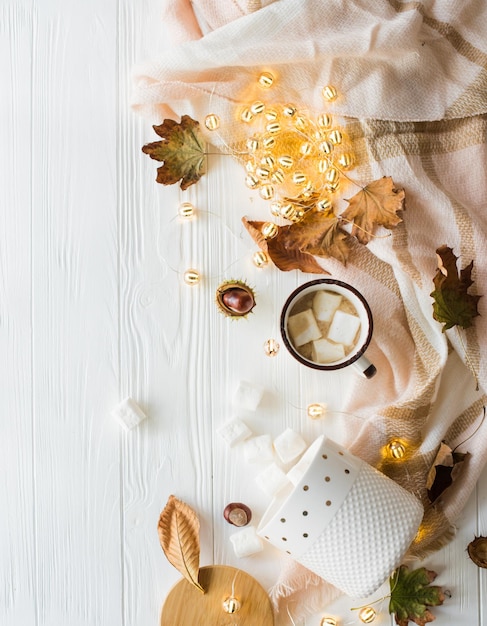 Fall still life with yellow leaves coffe with marshmallows and