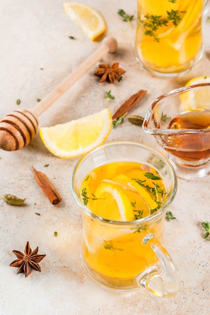 Fall and winter traditional drinks. Warming hot tea with lemon, ginger, spices (anise, cinnamon) and herbs (thyme), copyspace