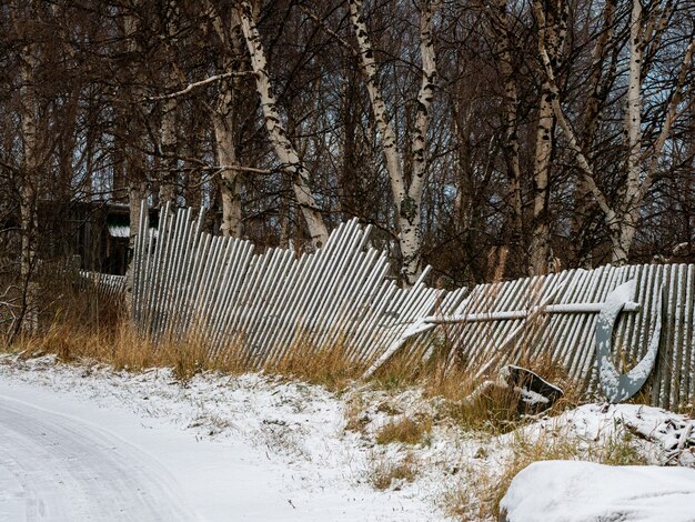 A fallen old wooden fence. Old fishing fence.