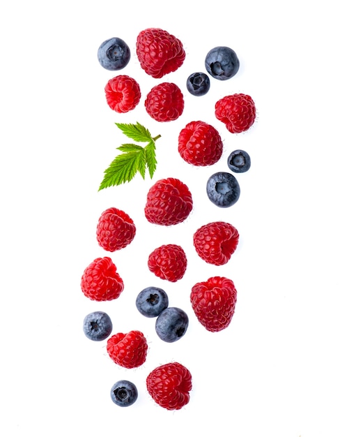 Photo falling  berry of raspberry and blueberries with leaves on white backgrounds. healthy food ingredient.