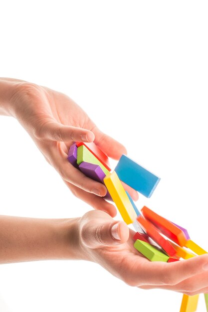 Falling colorful domino in hand