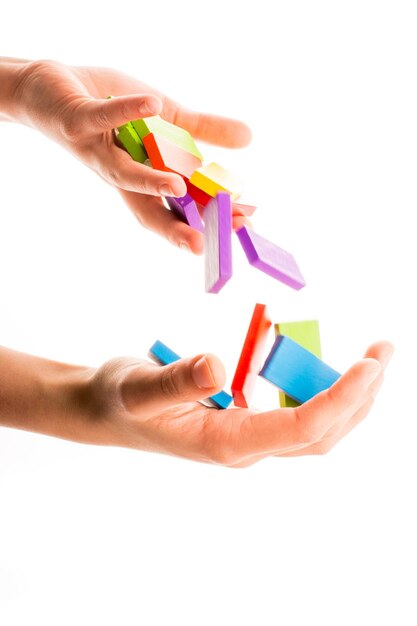 Falling colorful domino in hand