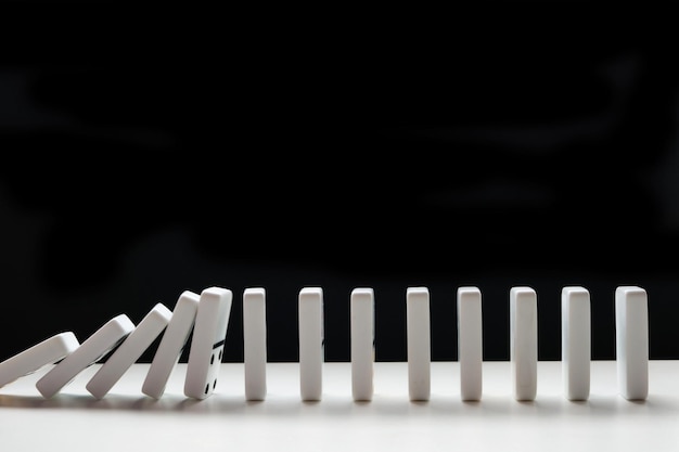 Photo falling domino chips on a black background