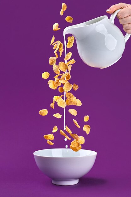 Photo falling granola with milk splash from dipper healthy breakfast ingredients flying food