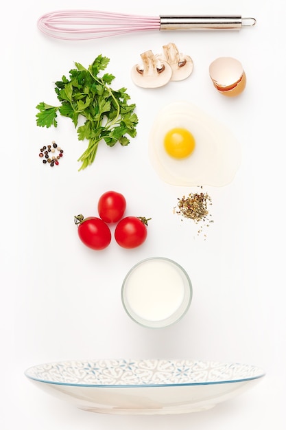 The falling ingredients of fried egg. Healthy breakfast ingredients. Flying food