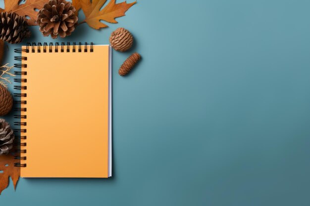 Falling into autumn a vibrant composition of notebooks autumn leaves and cones on a colorful back