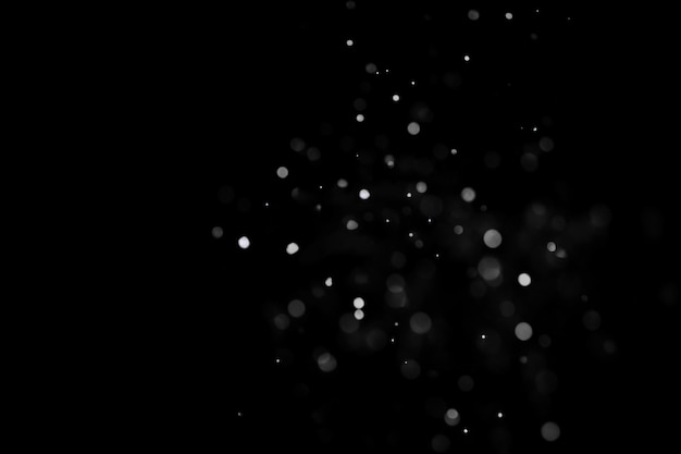 Falling snow isolated on black background