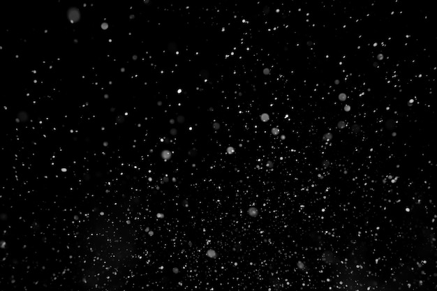 Photo falling snow isolated on black background