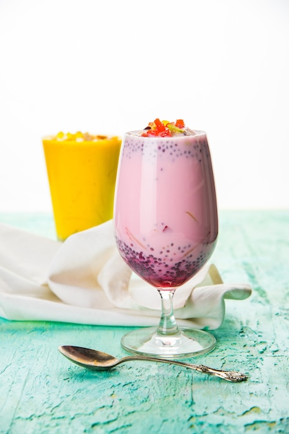 Falooda or Faluda is a popular Indian dessert - Strawberry and Mango flavoured which has Ice cream, noodles, sweet basil seeds and nuts, selective focus