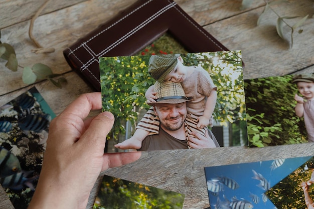 Famale hand holds printed photo from family photo archive