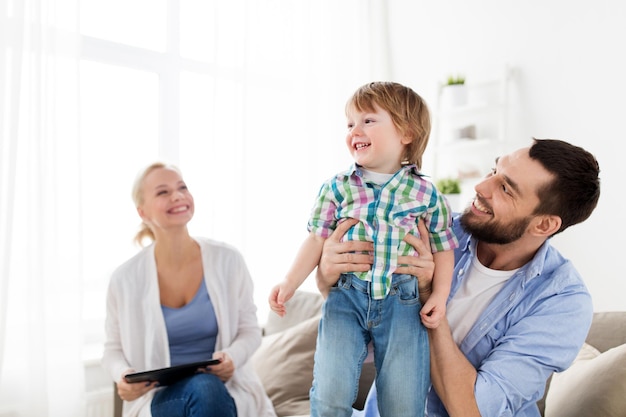familie, adoptie en mensenconcept - gelukkig kind met ouders thuis