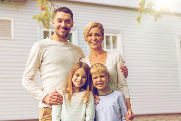 familie, geluk, generatie, huis en mensenconcept - gelukkige familie die buiten voor huis staat