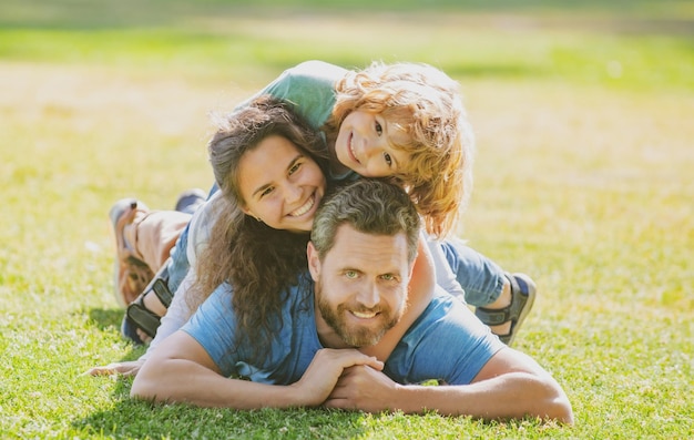 Familie knuffelen en omarmen op gras in park