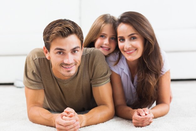 Familie poseren liggend op een tapijt