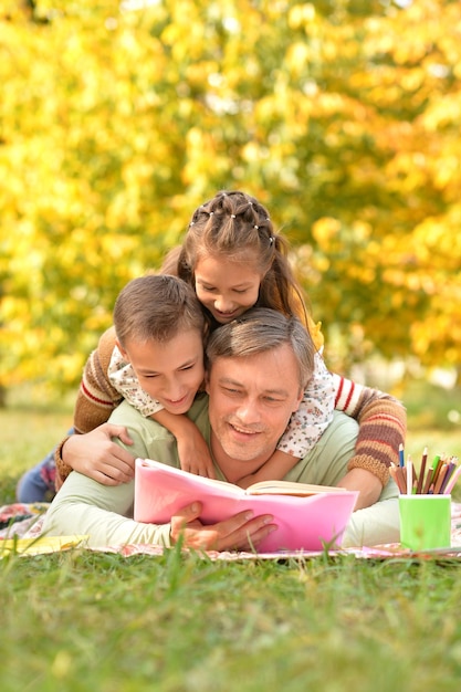 Familie rustend in park met boek