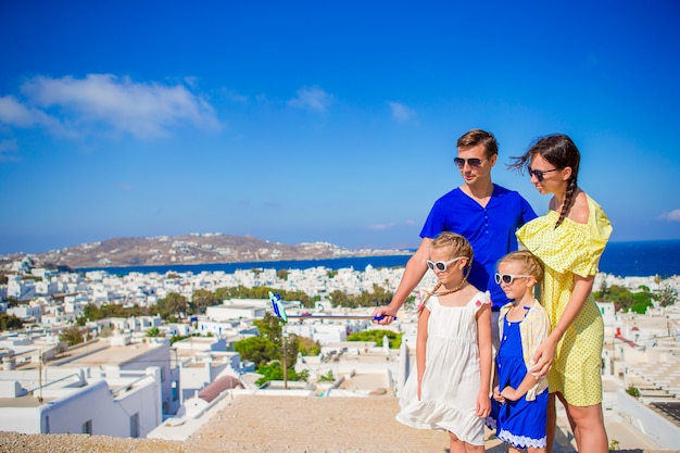 Familie vakantie in Europa. Ouders en kinderen nemen selfie foto achtergrond Mykonos-stad in Griekenland