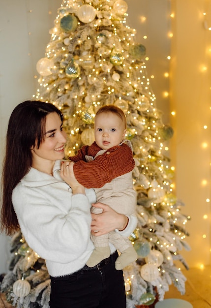 Families Portrait Of Happy Young Mother And Father with Child Posing In home Interior