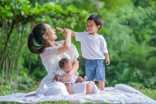 A family of 3 mother and son with a beautiful atmosphere in an Asian garden.