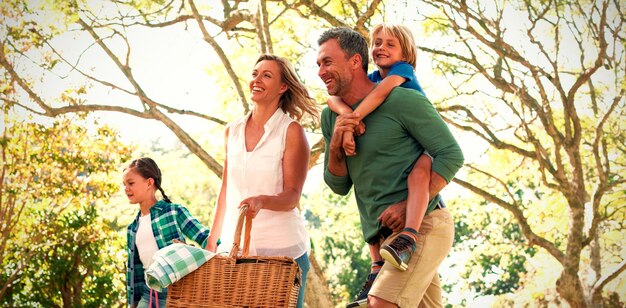 Family arriving in the park for picnic on a sunny day