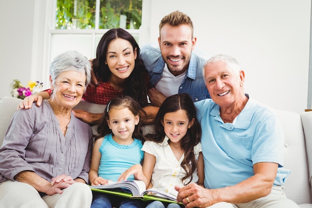 Family assisting girls while reading a book 