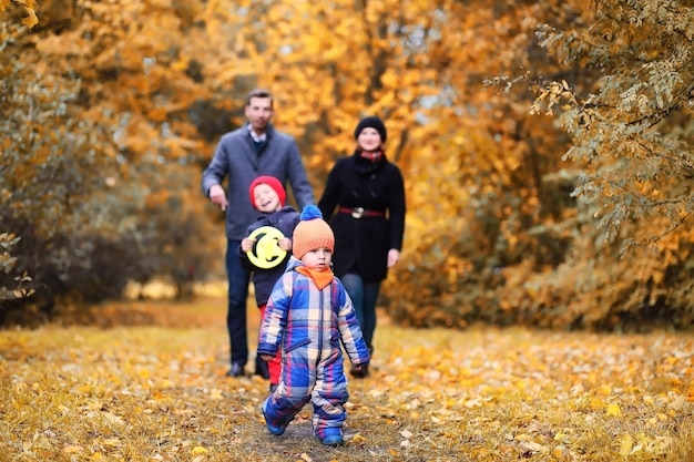 Family in autumn park in the afternoon